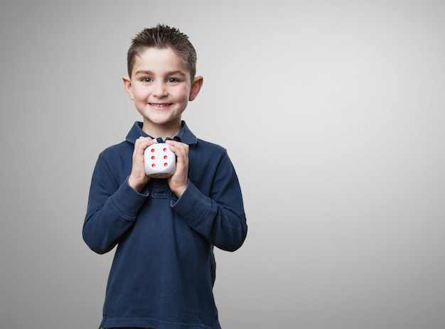 Smiling child with a die