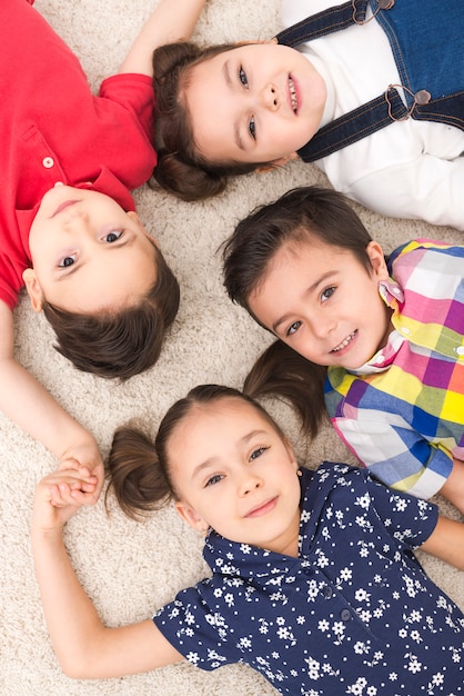 Smiling children lying down