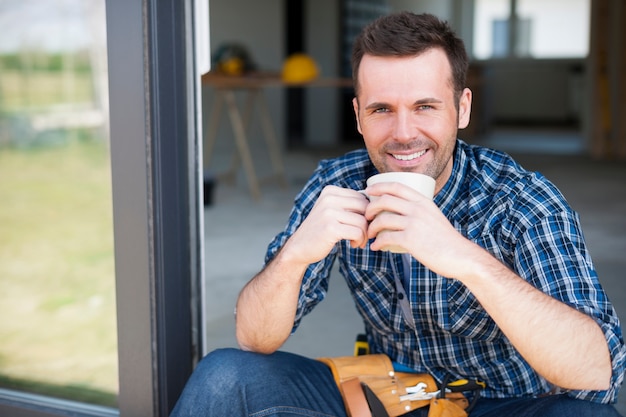 Smiling construction worker during the coffee brake