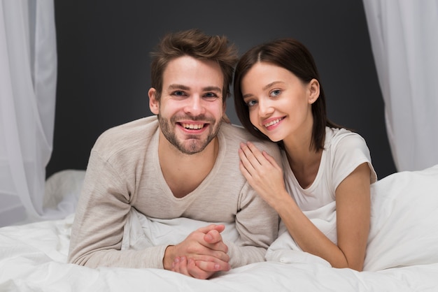 Smiling couple in bed