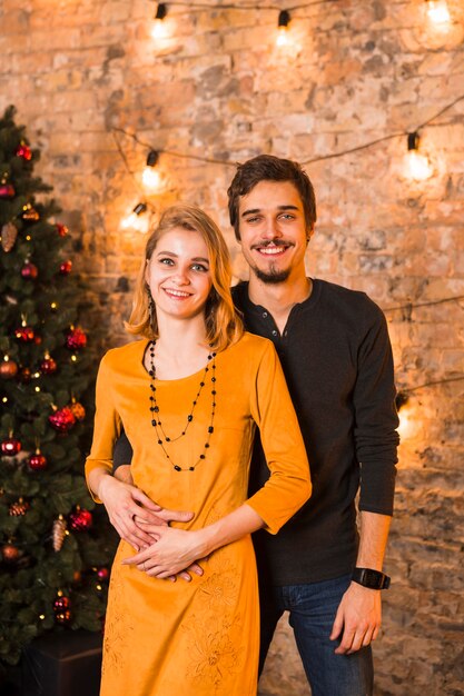 Smiling couple celebrating christmas together