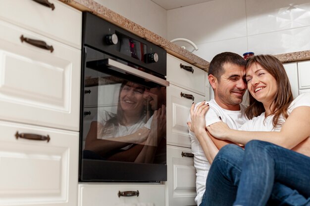 Smiling couple embracing in kitchen