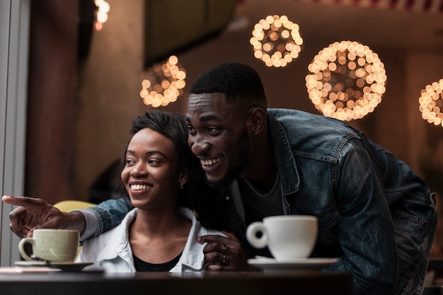 Smiling couple indoors looking away