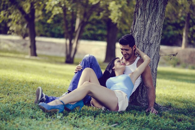 Smiling couple lying on the grass in a park