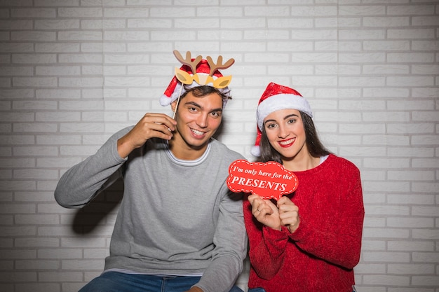 Free photo smiling couple posing with christmas decor
