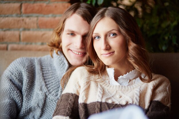 Smiling couple sitting close to each other