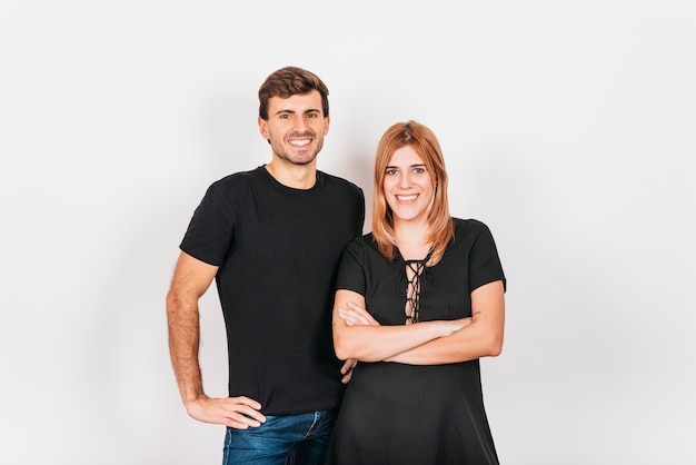 Free photo smiling couple smiling and standing against white background