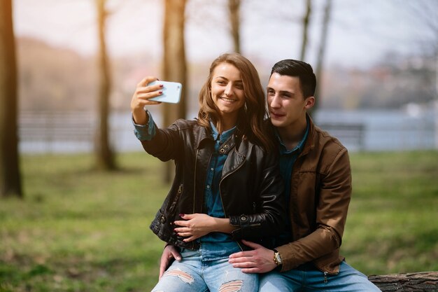 Улыбаясь пара, принимая фотографии на открытом воздухе