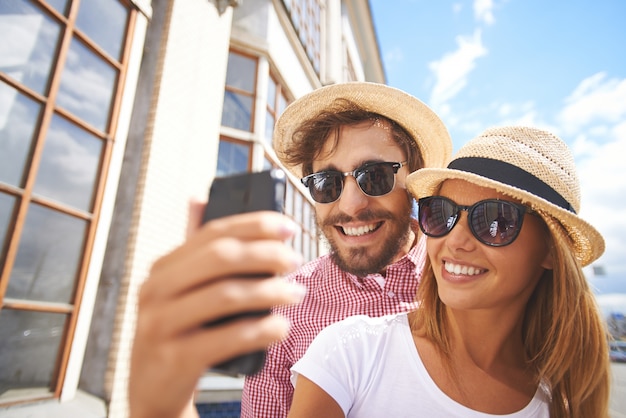 Smiling couple taking a selfie close-up