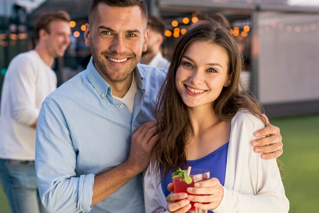 Smiling couple at a terrace party