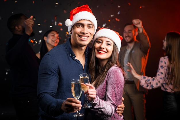 Smiling couple toasting at party