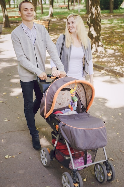 Smiling couple walking their baby