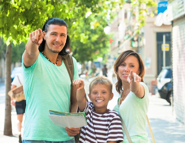 Free photo smiling couple with teenage child traveling together