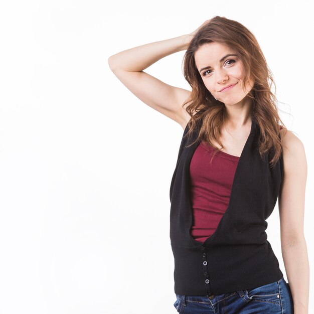 Smiling cute young woman against white backdrop