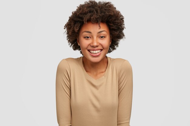 Smiling dark skinned woman has Afro hairstyle