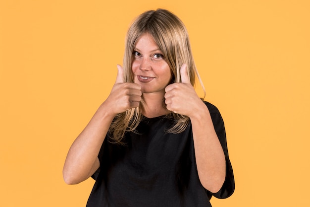 Free photo smiling disable woman showing thumb up gesture in sign language