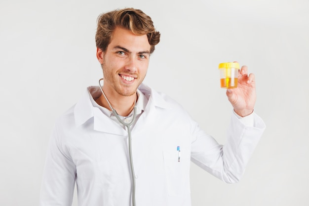 Smiling doctor holding container