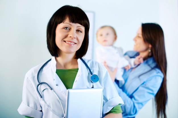 Smiling doctor holding tablet