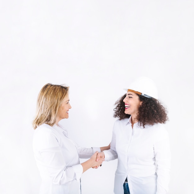 Free photo smiling engineers shaking hands