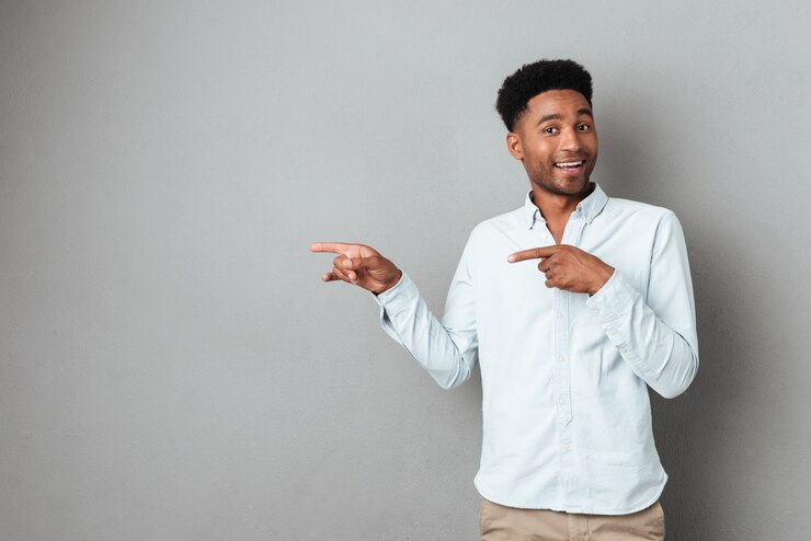 Free Photo smiling excited african man pointing finger away