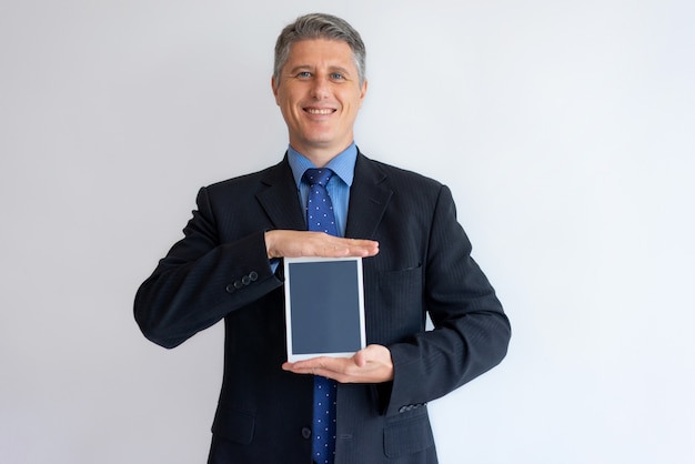 Smiling executive sharing information on tablet screen