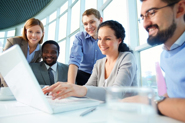 Smiling executives having meeting around table