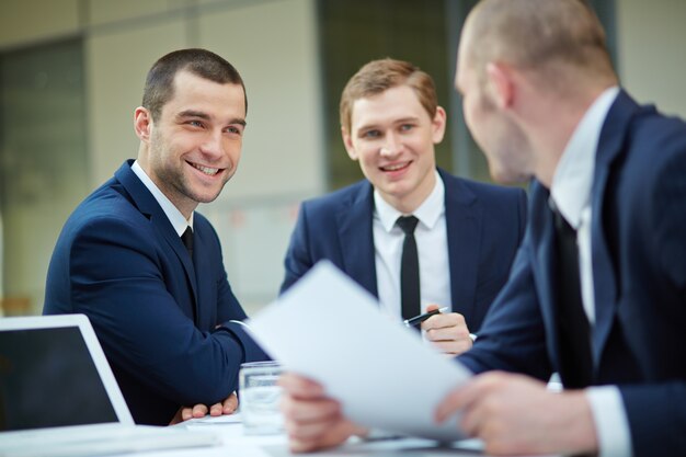 Smiling executives with paperwork