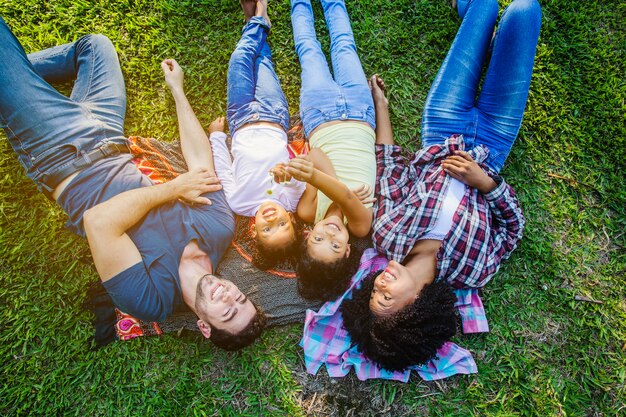 Smiling family lying on the grass