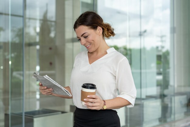 Smiling famous business lady reading article