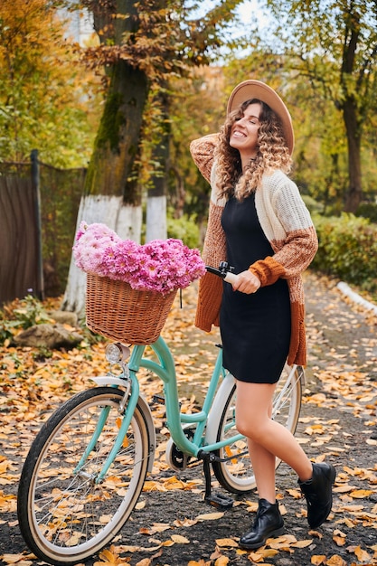 Free photo smiling female is riding bike on street