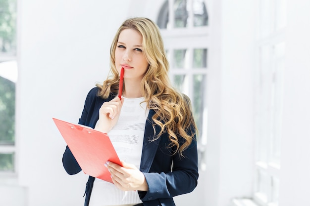 The smiling female office workers with laptop in office