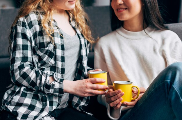 Smiling females holding coffee mugs