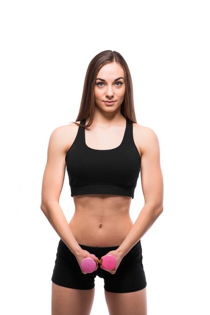 Улыбающаяся женщина фитнеса, тренирующаяся с гантелями, изолированными на белом фоне