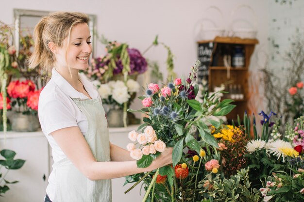 Smiling florist admiring bouquet
