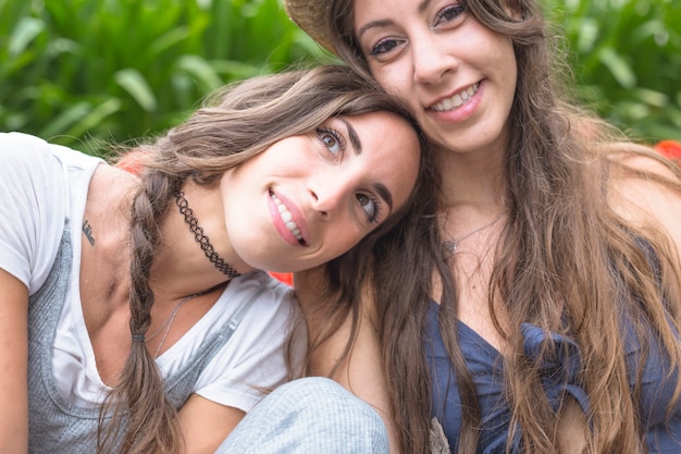 Smiling friend leaning on woman's shoulder