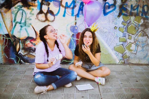 Smiling friends eating pastry