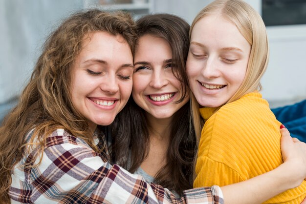 Smiling friends hugging