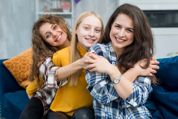 Smiling friends hugging