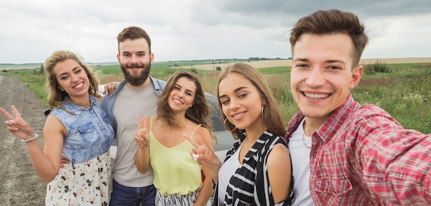 Free photo smiling friends taking self portrait at outdoors