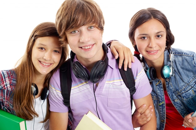 Smiling friends with headphones and books