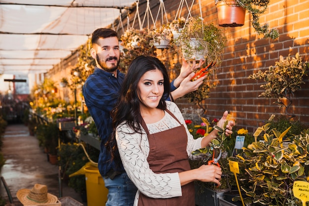 Free photo smiling gardeners with pruners