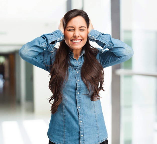 Smiling girl covering her ears