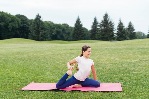 Smiling girl exercising in nature