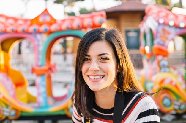 Smiling girl in front of a ride