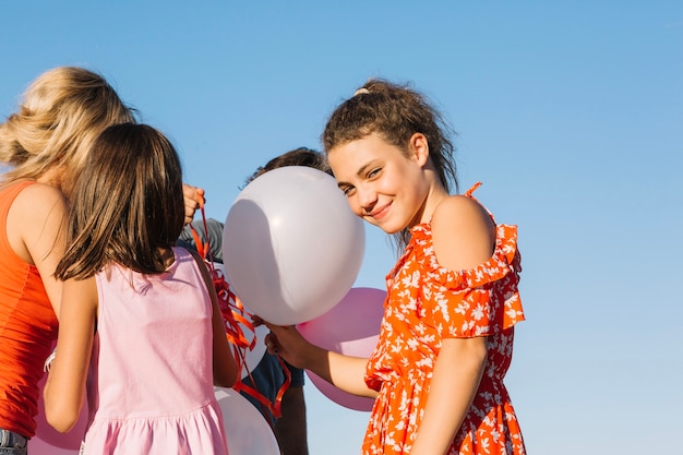 Free photo smiling girl holding balloons