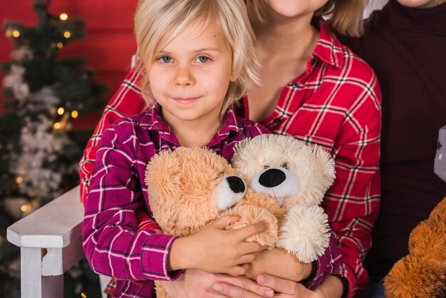 Smiling girl holding teddy bears