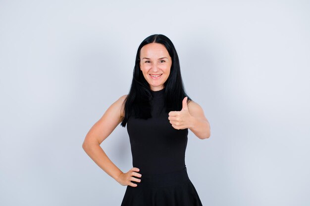 Smiling girl is showing perfect gesture on white background