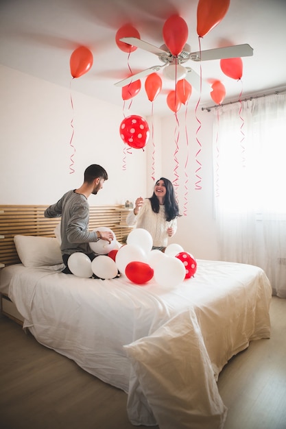 Free photo smiling girl looking at balloons on the roof