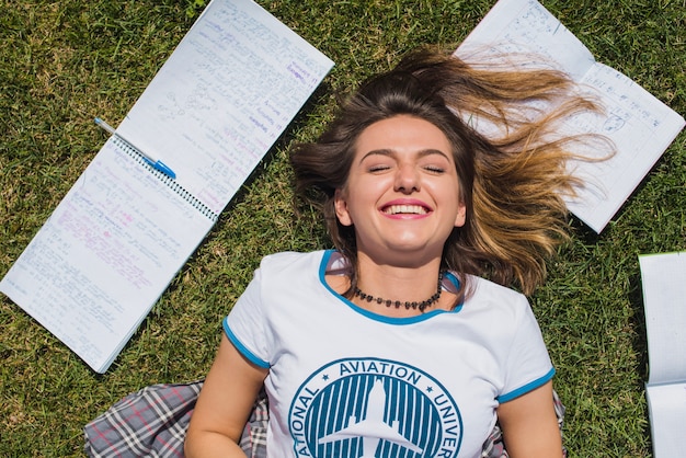 Smiling girl lying on grass