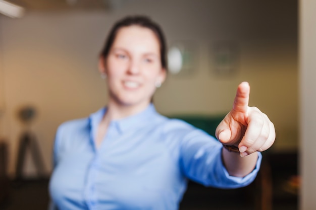 Free photo smiling girl pointing with finger